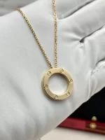 Cartier Love Pendant B7014200 in 18k yellow gold, side view on a white glove