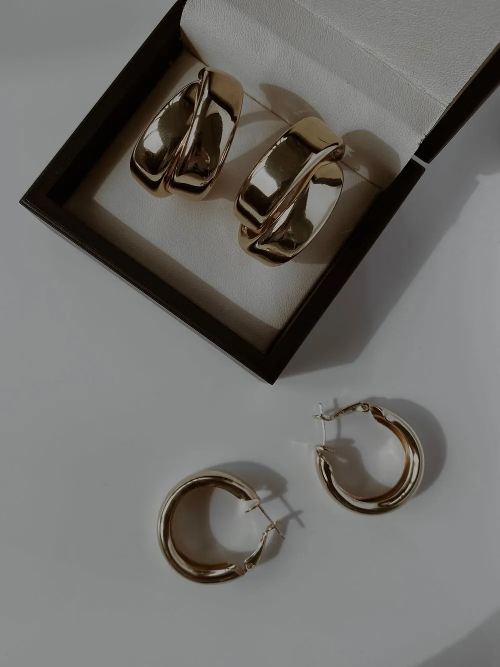 Designer hoop earrings displayed in an open jewelry box