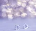 How to clean diamond earrings: sparkling diamond studs on a lilac background