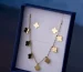 Gold clover necklace in a gift box, a lookalike to check when you spot a fake Van Cleef Alhambra necklace