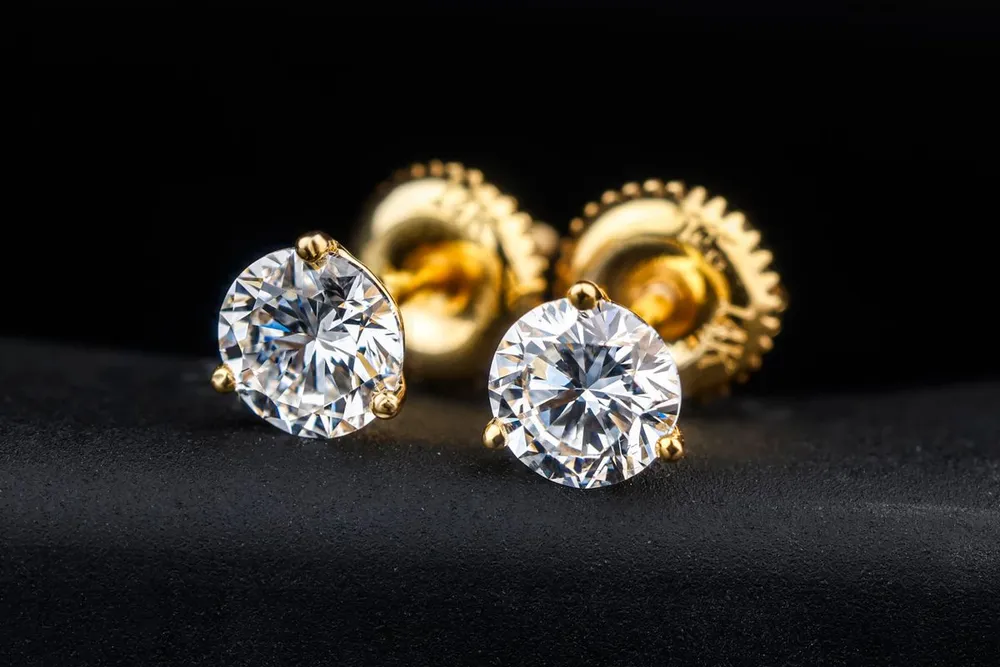 Gold and diamond stud earrings ready for home cleaning