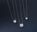 Three designer pieces of a luxury diamond necklace in Dubai on a blue background