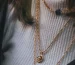 Layered gold chains on the neck, a necklace length guide example