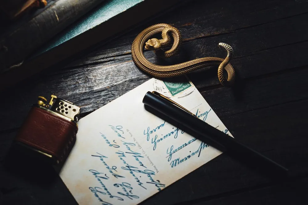 Bvlgari Serpenti bracelet style: a gold snake-shaped bracelet coiled on a dark wooden table