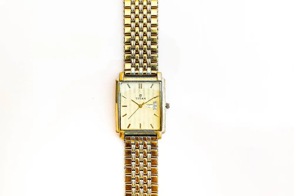 Vintage Cartier Santos in Dubai style check: a square gold watch on a mesh bracelet