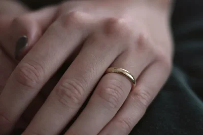 Cartier Love ring price guide: a plain gold band worn on a finger