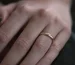 Cartier Love ring price guide: a plain gold band worn on a finger