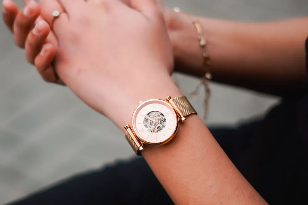 Bvlgari Serpenti watch vs Cartier Panthere: a rose gold ladies watch with a skeleton dial on a woman's wrist