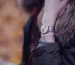 Cartier Santos medium vs large: a silver wristwatch worn on the wrist outdoors
