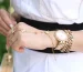 Cartier Love bracelet worth it: a gold bracelet and a gold watch on a wrist