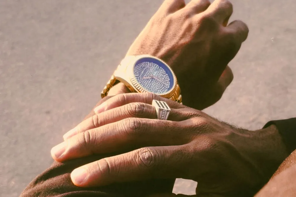 Gold diamond-dial watch worn on the wrist, showing how case size looks on a hand