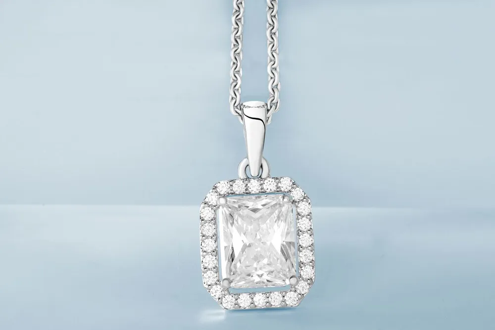 Messika Move Uno necklace in Dubai, pavé diamond pendant on a light blue background
