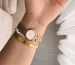 Cartier Panthere watch small style: a small gold watch worn on a woman's wrist